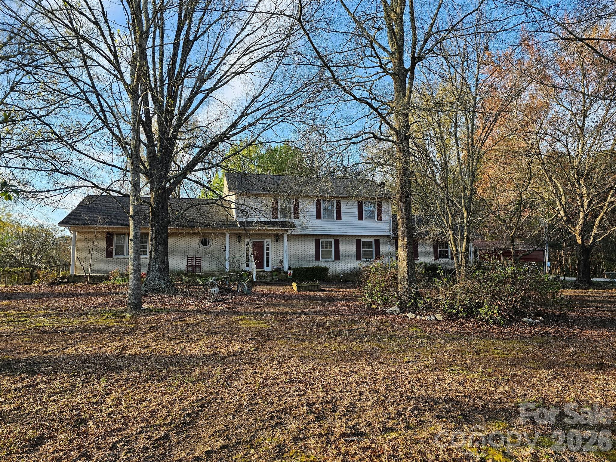 979 Suttle Road Lancaster, SC 29720 - Photo 2 of 26 a tree in front of a brick house with large trees