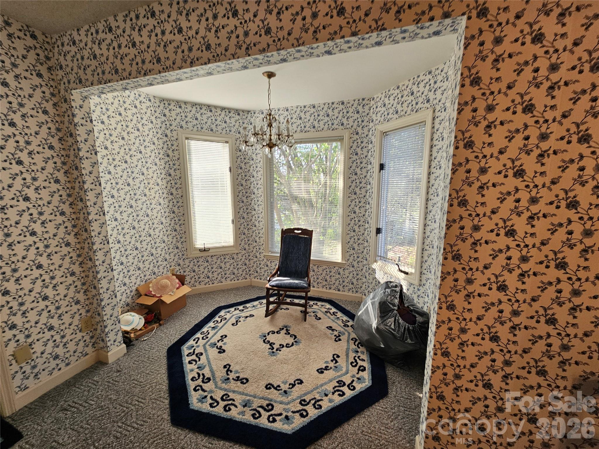 979 Suttle Road Lancaster, SC 29720 - Photo 22 of 26 a view of a bedroom with a bed and a chandelier