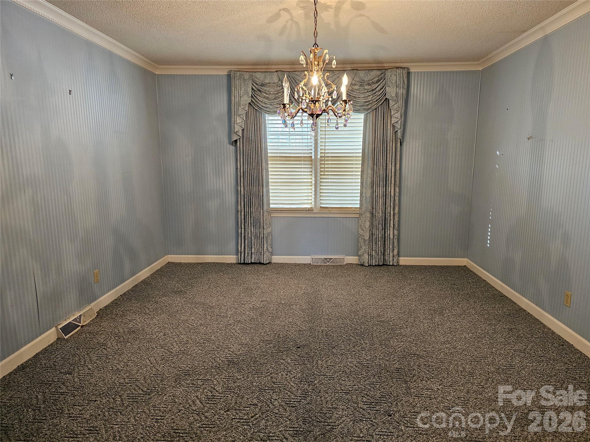 979 Suttle Road Lancaster, SC 29720 - Photo 6 of 26 en empty room with windows and chandelier