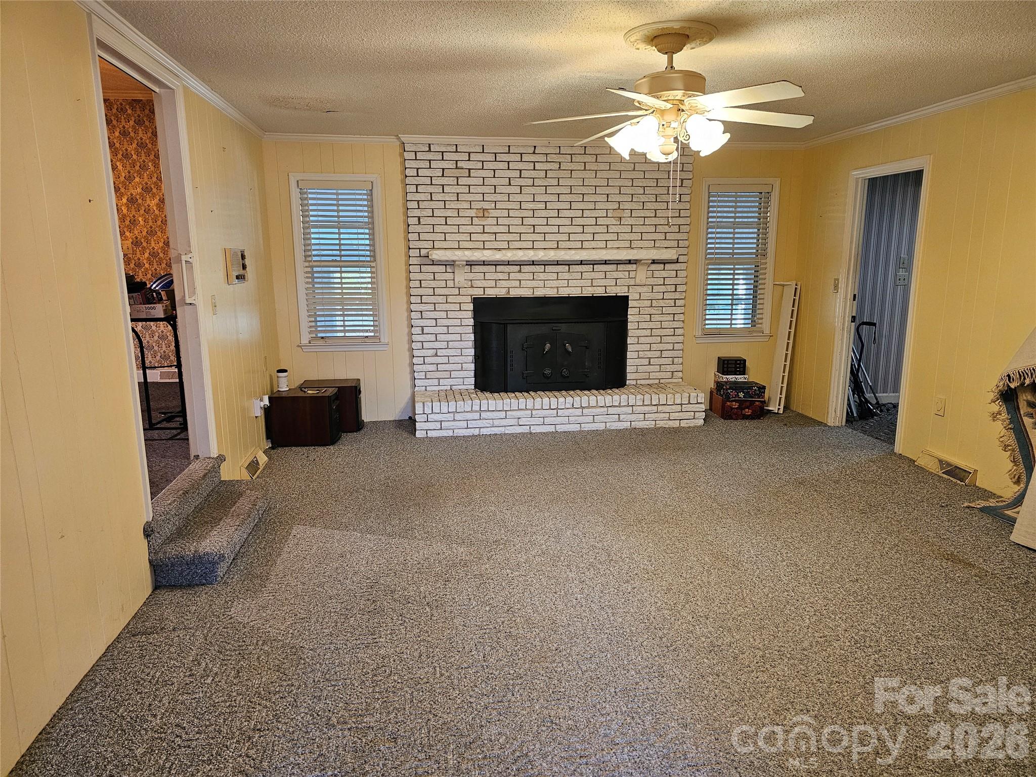 979 Suttle Road Lancaster, SC 29720 - Photo 10 of 26 a view of a livingroom with a fireplace and a ceiling fan
