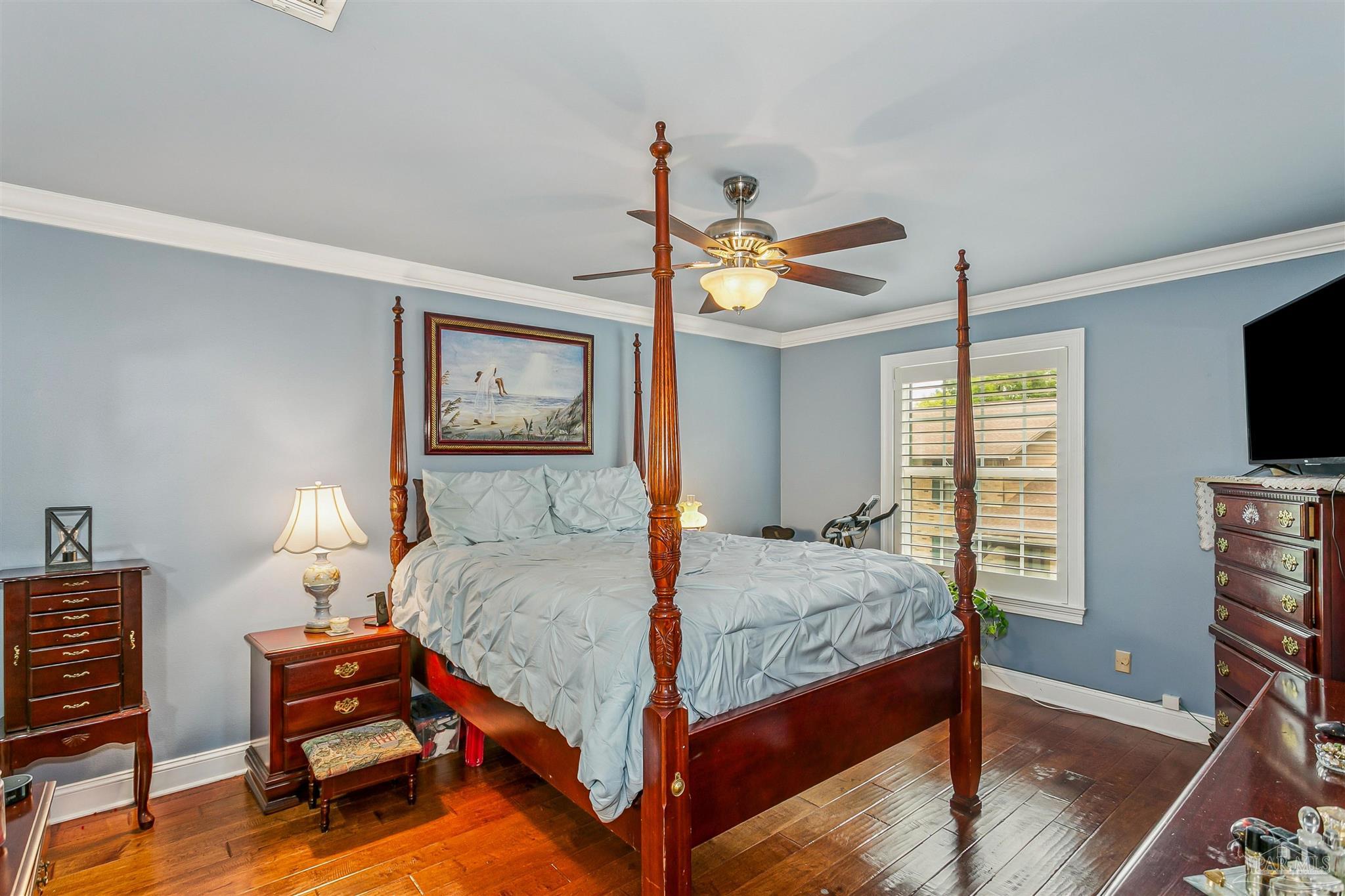 4831 East Olive Road, Unit 2D Pensacola, FL 32514 - Photo 22 of 29 a bed room with a bed and a flat screen tv