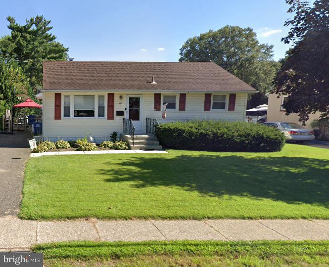 Charming home with lush green lawn.