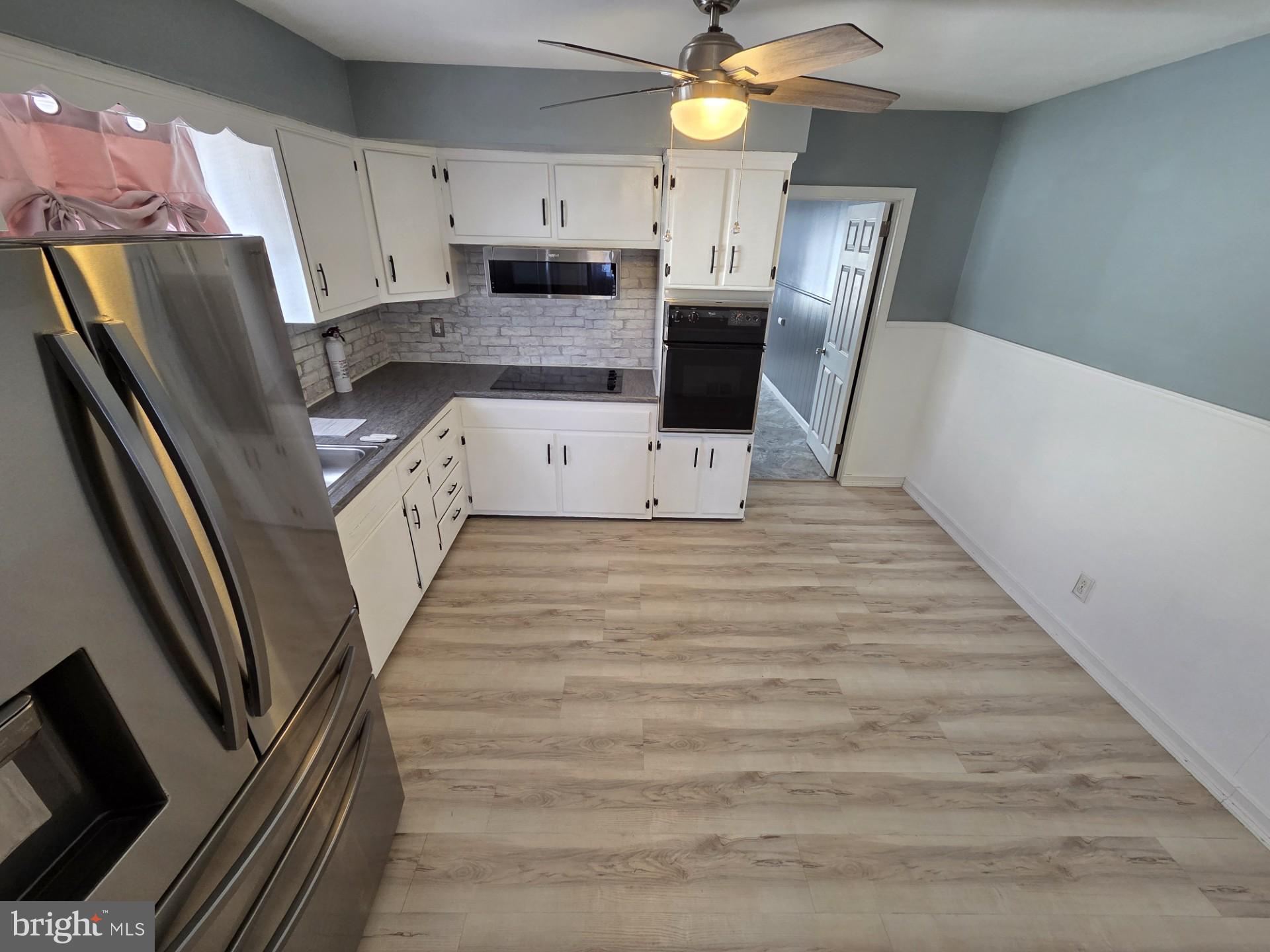 48 5th Avenue Maple Shade, NJ 08052 - Photo 17 of 31 a large white kitchen with wooden floor