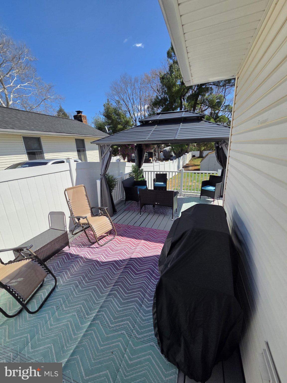 48 5th Avenue Maple Shade, NJ 08052 - Photo 4 of 31 a view of a patio with table and chairs with wooden floor and fence