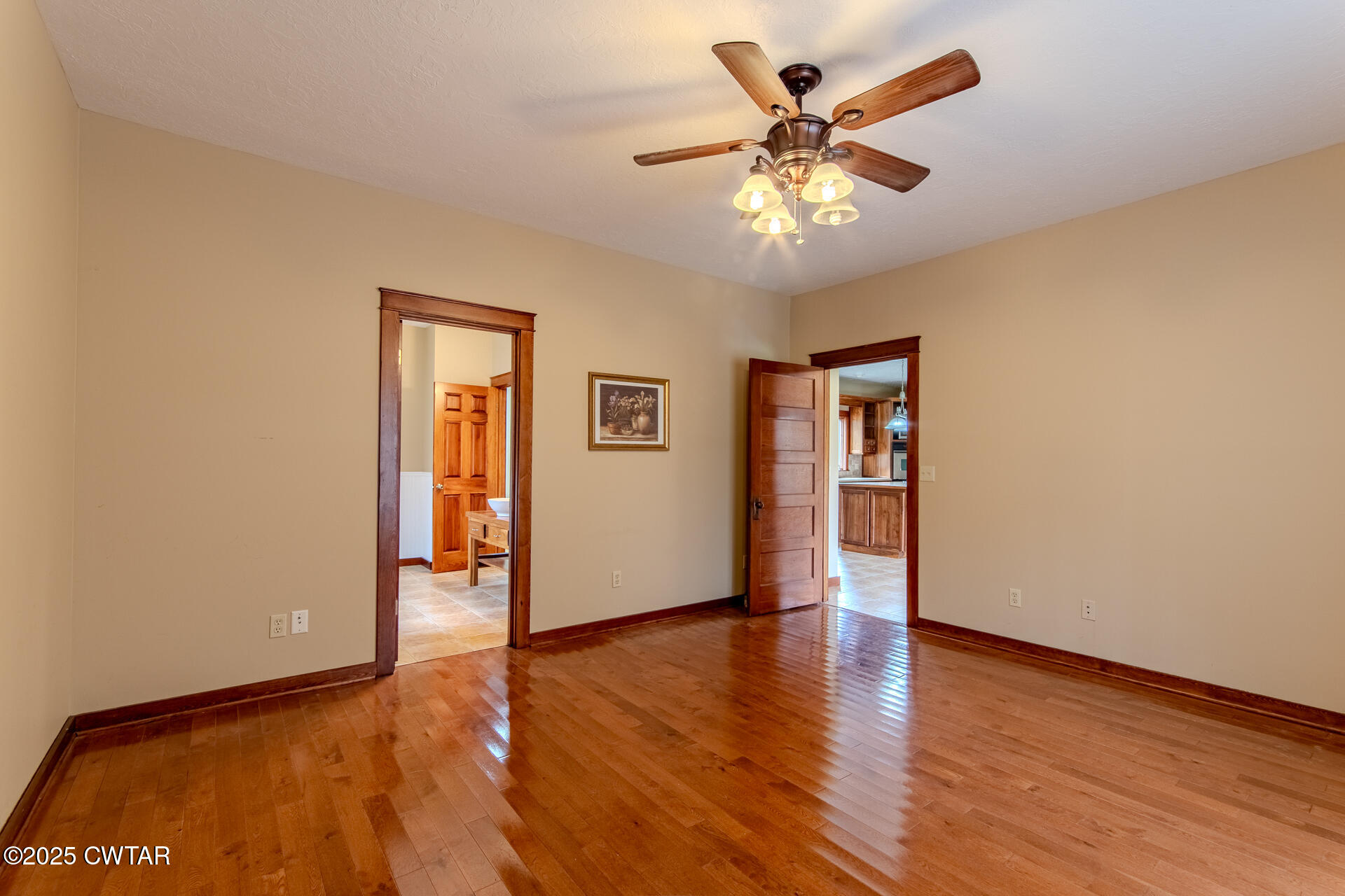 3554 Shades Bridge Road Greenfield, TN 38230 - Photo 22 of 49 an empty room with wooden floor chandelier fan and windows