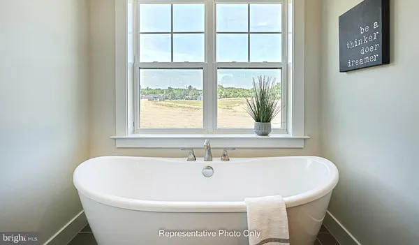 a white bath tub sitting next to a window