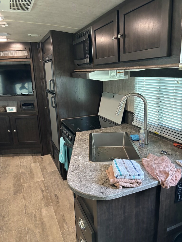 114 Red Snapper Drive Port Lavaca, TX 77979 - Photo 35 of 44 a kitchen with a sink a refrigerator and chairs