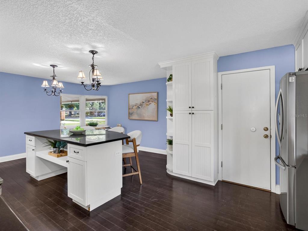 333 Cornwall Road Winter Park, FL 32792 - Photo 9 of 32 a kitchen with stainless steel appliances a kitchen island hardwood floor and a sink