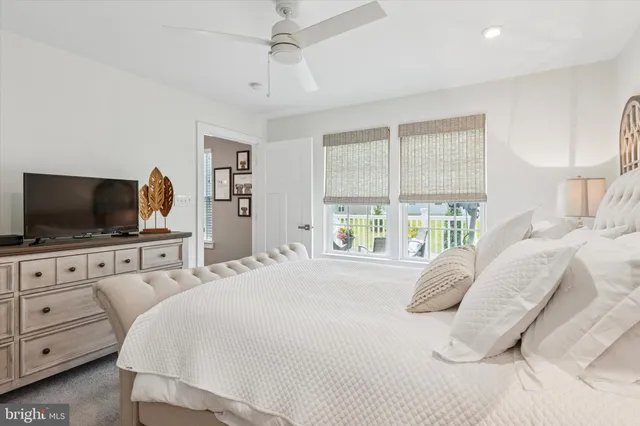 a bedroom with a large bed and flat tv