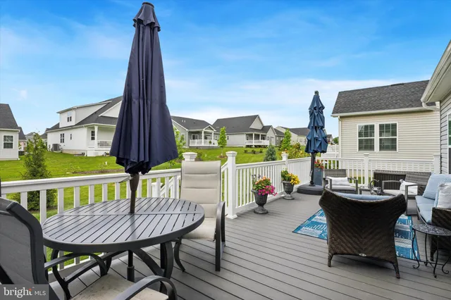 a view of a roof deck with table and chairs