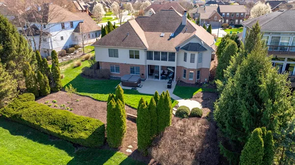 an aerial view of a house with yard swimming pool and outdoor seating