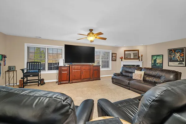 a bedroom with a bed and a ceiling fan