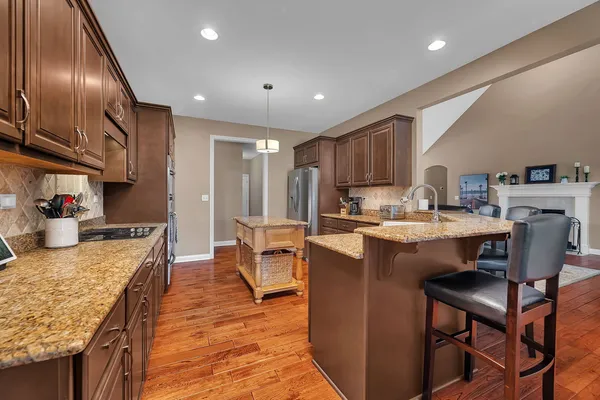a kitchen with granite countertop stainless steel appliances and wooden cabinets