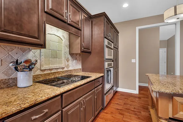 a kitchen with stainless steel appliances granite countertop a refrigerator and a sink