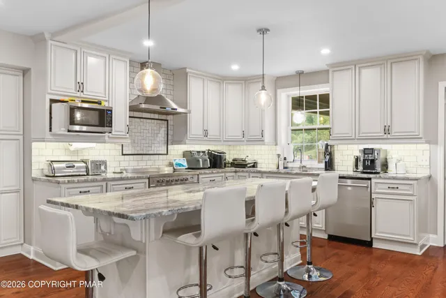 a bathroom with a sink a mirror a shower and a bathtub