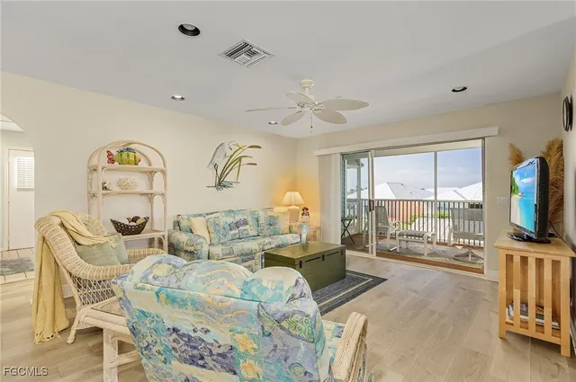 a living room with furniture dining table and a large window