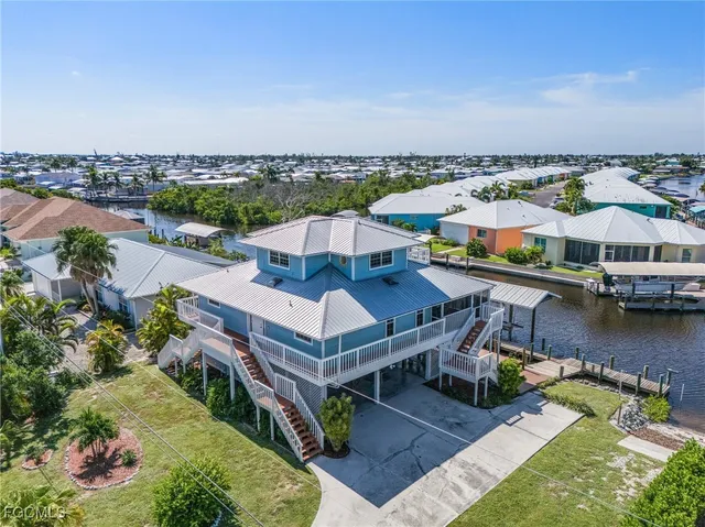 an aerial view of a house with a lake view