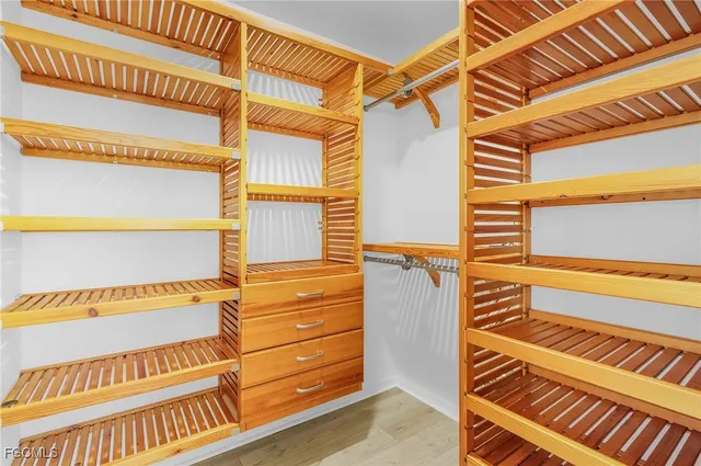 a bathroom with a granite countertop shower a sink and a mirror