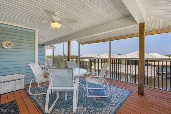 a view of a balcony with chair and wooden floor