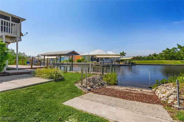 a view of a house with backyard and sitting area