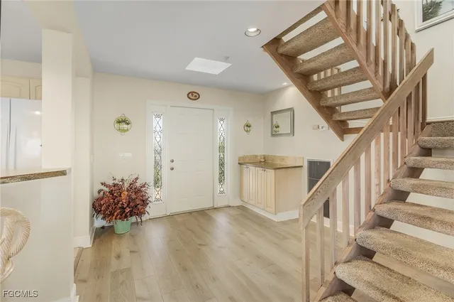 a view of entryway and hall with wooden floor