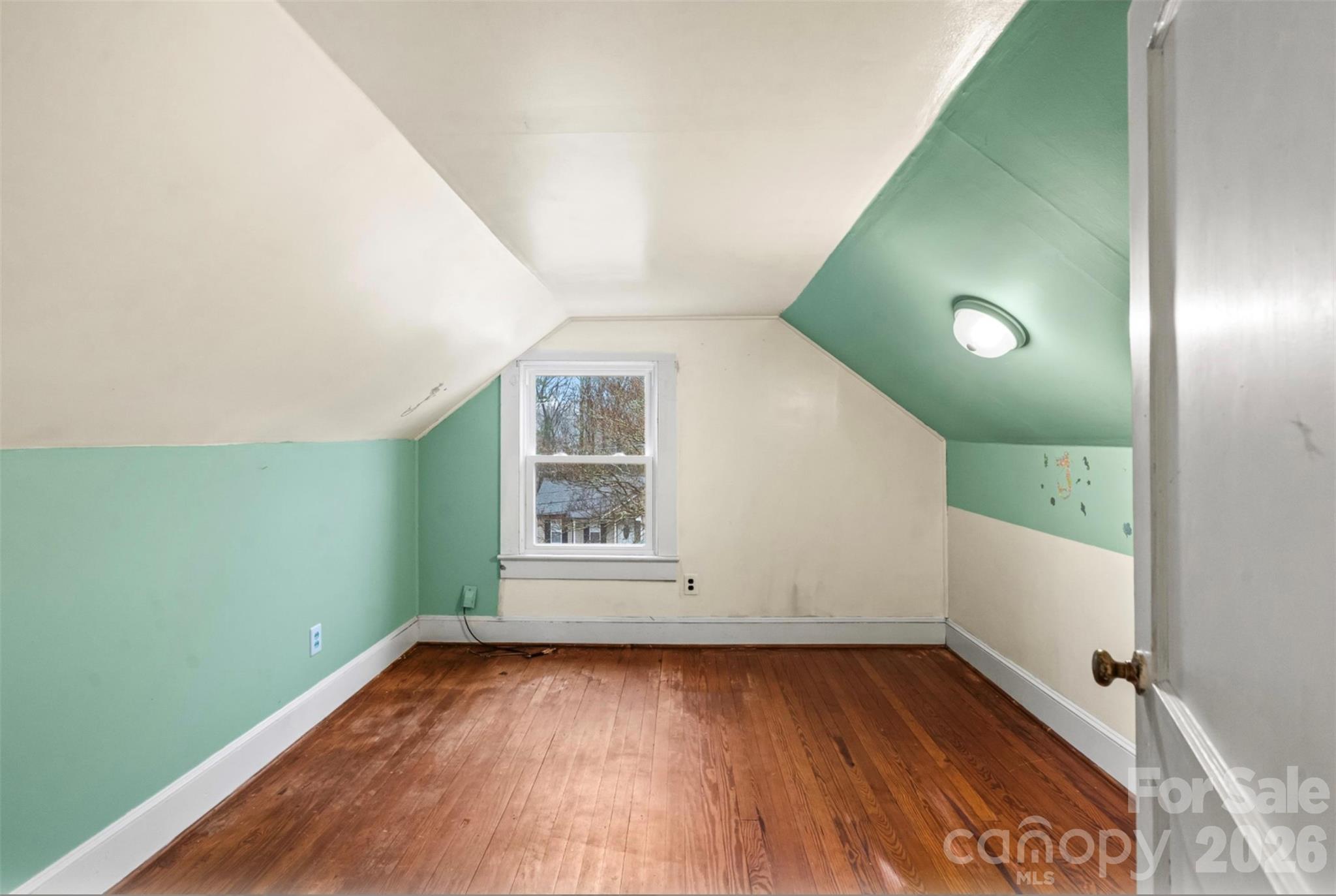 1409 Venus Street Kannapolis, NC 28083 - Photo 14 of 22 an empty room with wooden floor and windows