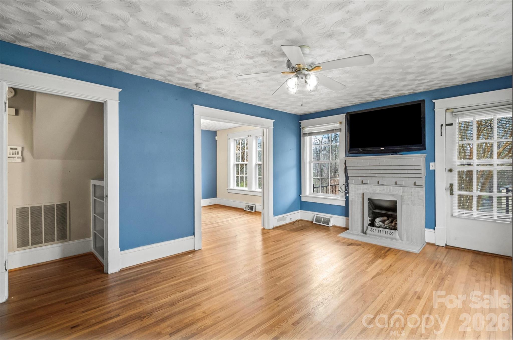1409 Venus Street Kannapolis, NC 28083 - Photo 4 of 22 a view of a livingroom with a fireplace wooden floor and cabinet