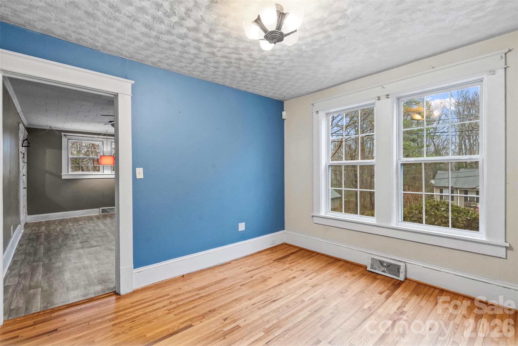 1409 Venus Street Kannapolis, NC 28083 - Photo 5 of 22 an empty room with wooden floor and windows