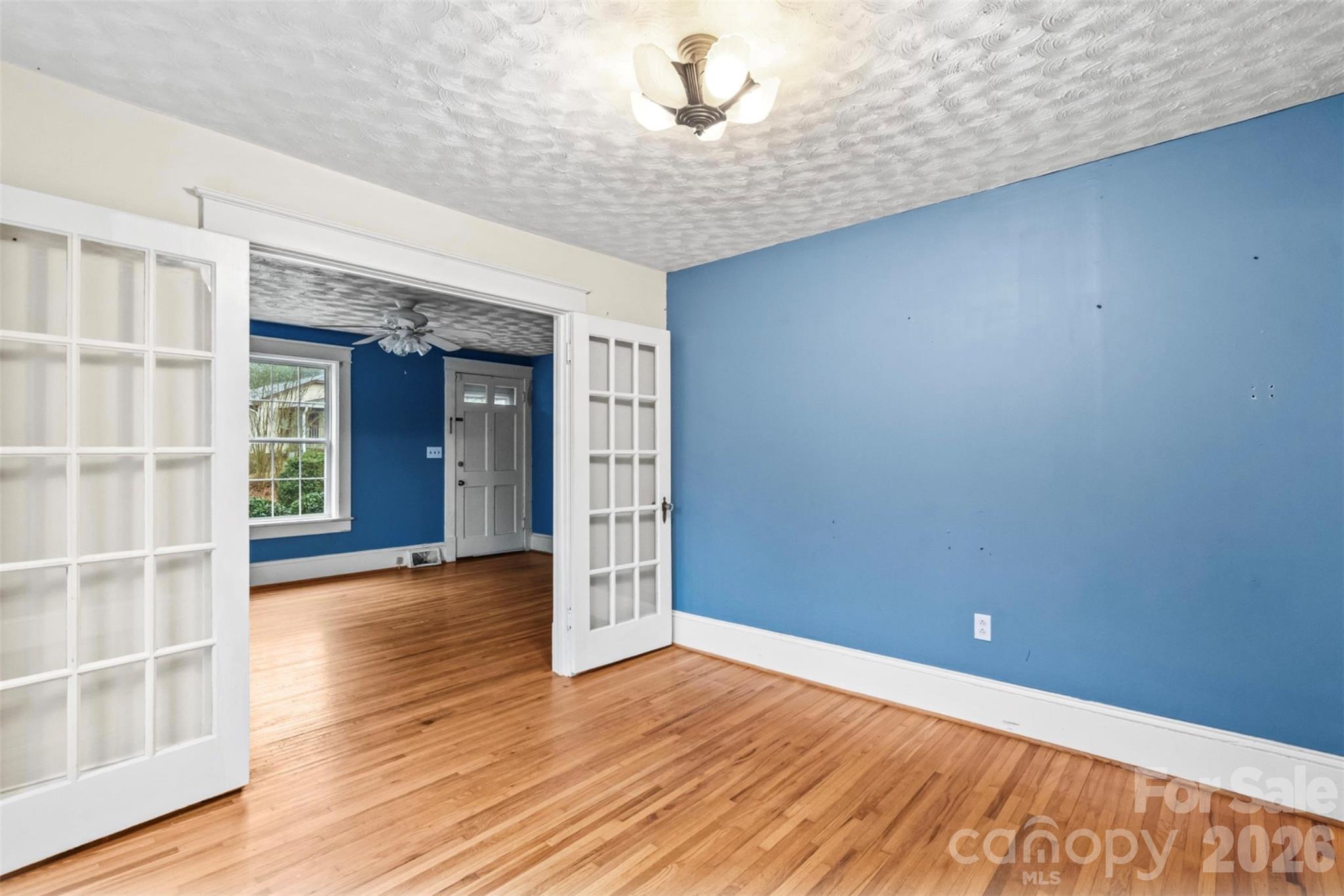 1409 Venus Street Kannapolis, NC 28083 - Photo 6 of 22 a view of an empty room with wooden floor and a window