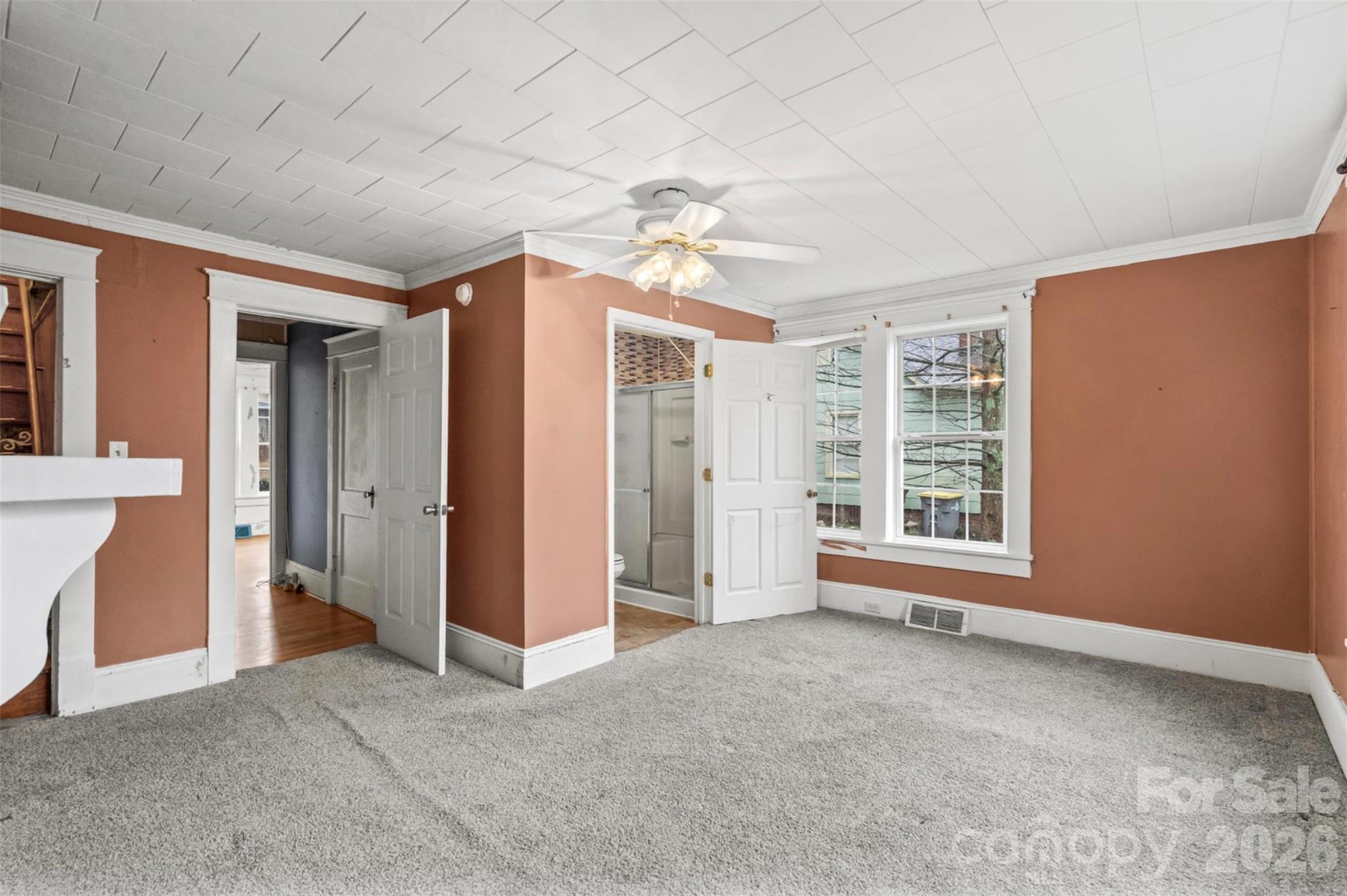 1409 Venus Street Kannapolis, NC 28083 - Photo 10 of 22 an empty room with chandelier fan and windows