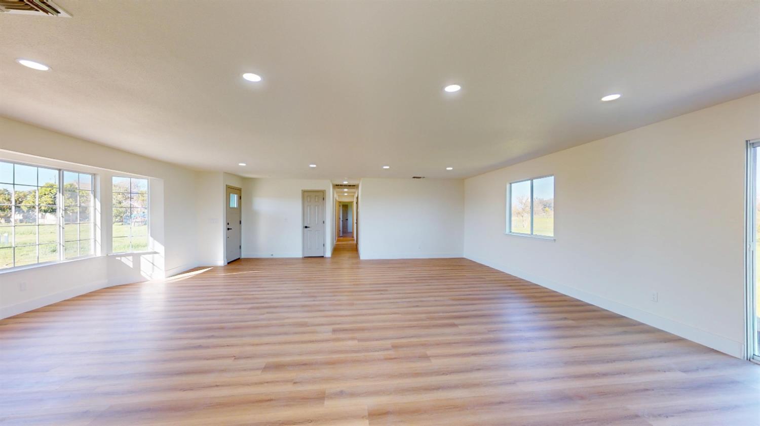 16363 Paula Road Madera, CA 93636 - Photo 3 of 29 a view of an empty room with wooden floor and a window