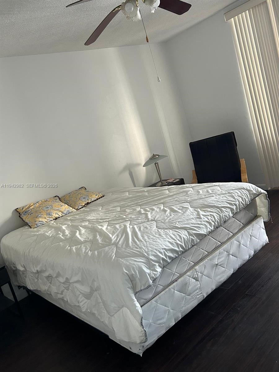 1150 Northeast 191st Street, Unit 45 Miami, FL 33179 - Photo 4 of 10 a bedroom with a bed and window