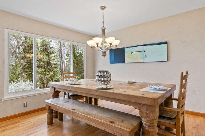 1159 Barcelona Drive Pacifica, CA 94044 - Photo 11 of 67 a dining room with wooden floor a chandelier a wooden table and chairs