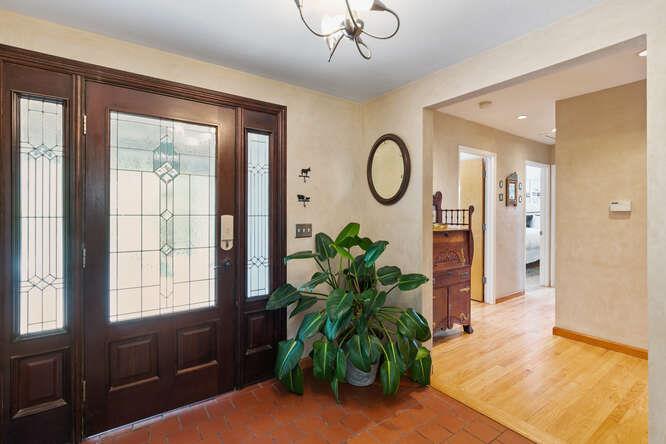 1159 Barcelona Drive Pacifica, CA 94044 - Photo 23 of 67 a view of a hallway with wooden floor and a chandelier