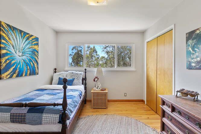 1159 Barcelona Drive Pacifica, CA 94044 - Photo 25 of 67 a bedroom with a bed and a painting on the wall