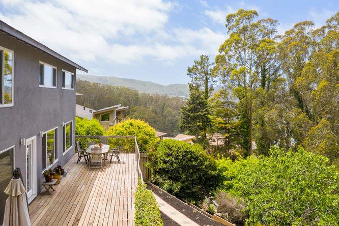 1159 Barcelona Drive Pacifica, CA 94044 - Photo 52 of 67 a balcony with wooden floor and bench