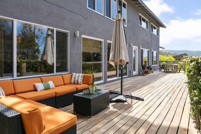 1159 Barcelona Drive Pacifica, CA 94044 - Photo 54 of 67 a view of a roof deck with couches floor to ceiling window with wooden floor