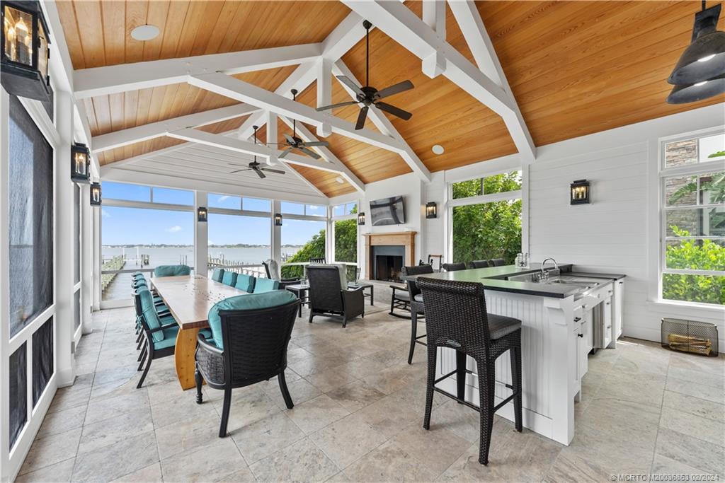 1441 Southeast Riverside Drive Stuart, FL 34996 - Photo 17 of 73 a view of a patio with a dining table and chairs