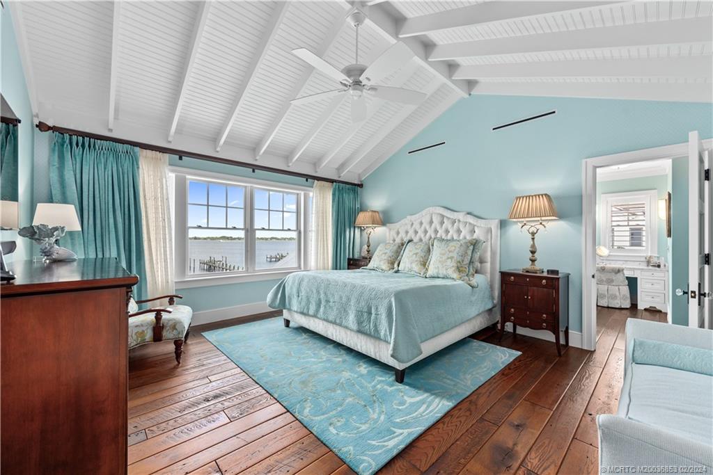1441 Southeast Riverside Drive Stuart, FL 34996 - Photo 34 of 73 a bedroom with a bed wooden floor and window