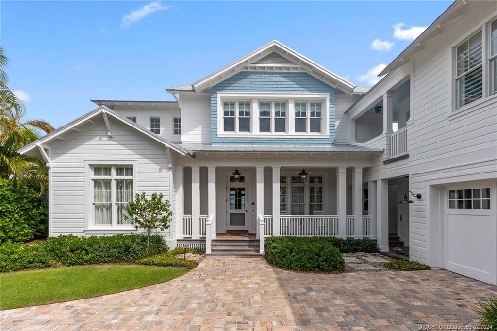 1441 Southeast Riverside Drive Stuart, FL 34996 - Photo 4 of 73 a front view of a house with garden