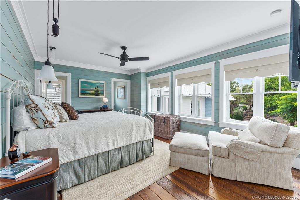 1441 Southeast Riverside Drive Stuart, FL 34996 - Photo 44 of 73 a bedroom with a large bed couch and a window