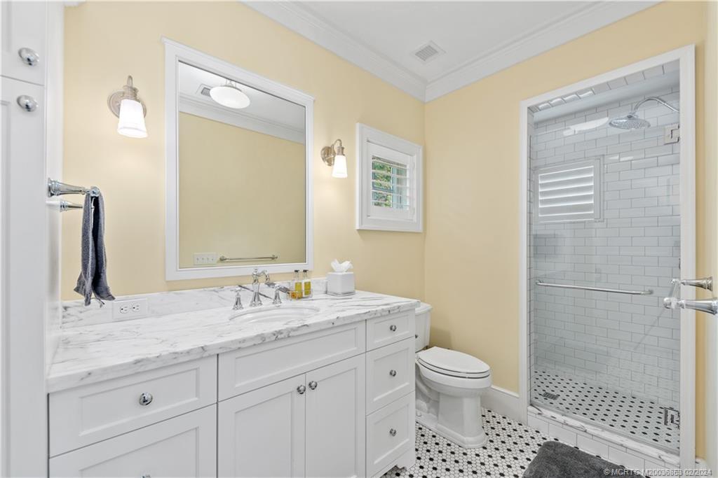 1441 Southeast Riverside Drive Stuart, FL 34996 - Photo 66 of 73 a bathroom with a toilet a sink and shower