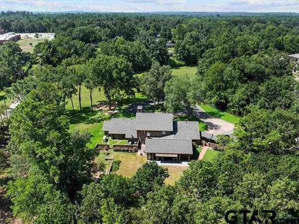 an aerial view of a house with a yard