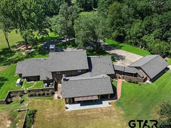 an aerial view of a house with swimming pool garden and patio
