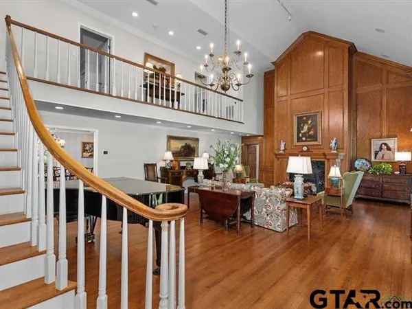 a living room with furniture and a chandelier