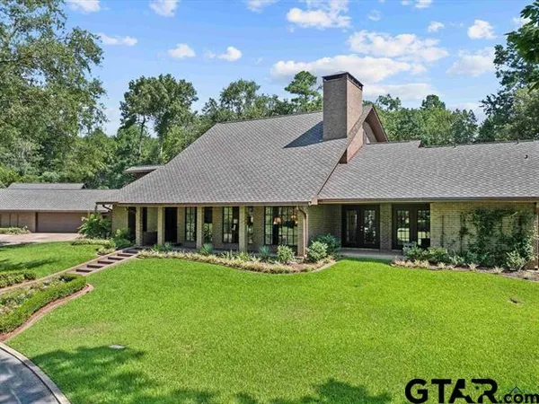a view of a house with garden and a patio
