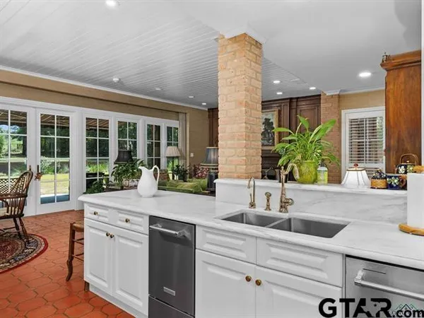 a kitchen with a sink and large window