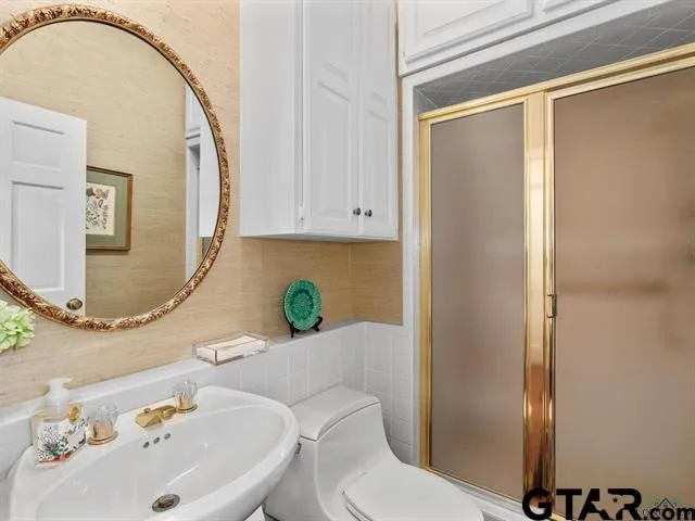 a bathroom with a sink mirror vanity and toilet