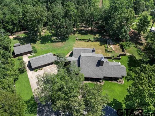 an aerial view of a house with yard and outdoor seating