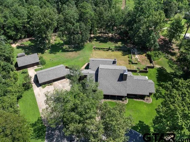 an aerial view of a house with yard and outdoor seating